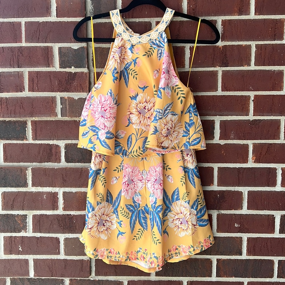 Blue Rair sleeveless romper with back zipper and a back tie.